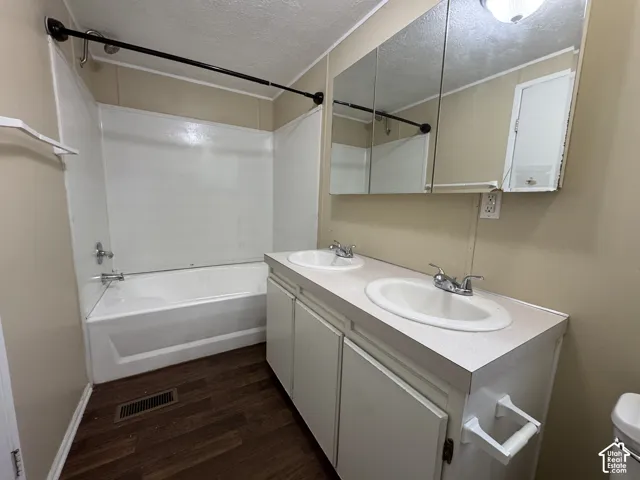 Bathroom featuring a double vanity with integrated sinks and a medicine cabinet with mirrored fronts