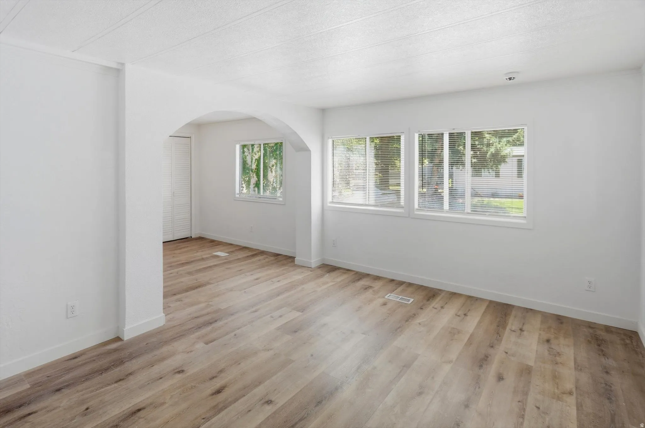 Light wood-finish flooring throughout the room