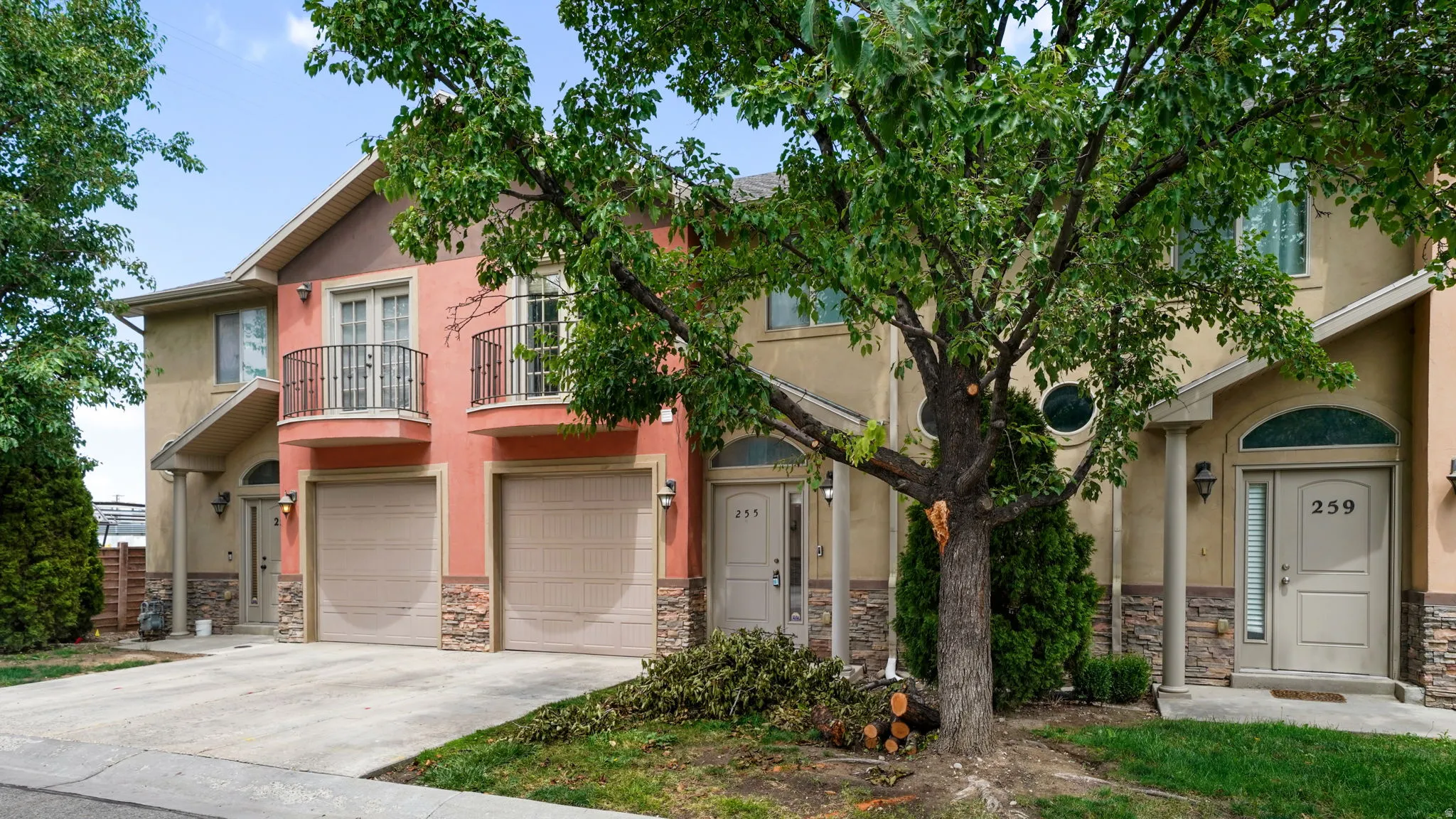 Multi-story townhouse exterior featuring a stucco and stone facade