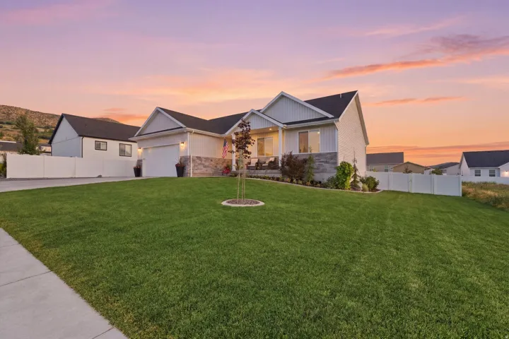 Expansive front lawn with a concrete walkway