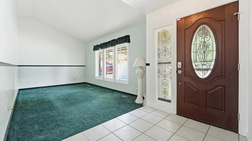 Entry foyer featuring light-toned tile flooring