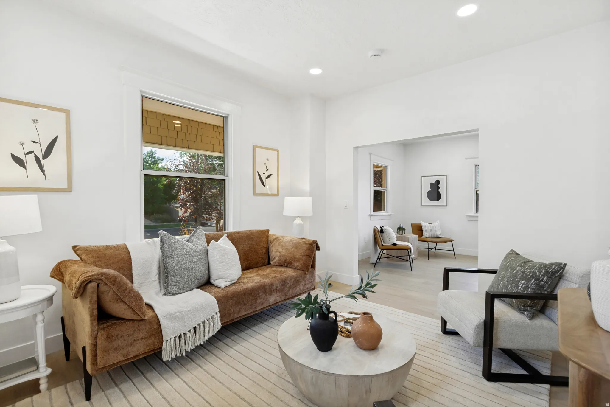 Bright living space featuring recessed lighting, light wood-finish flooring, and white trim