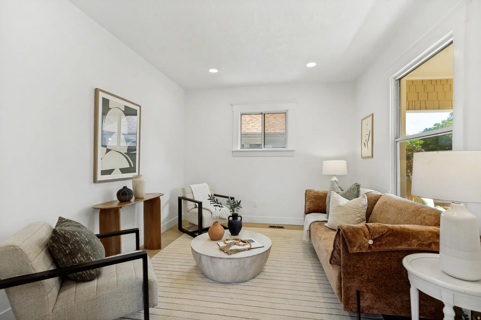 Bright living area featuring recessed lighting and wood-finish flooring