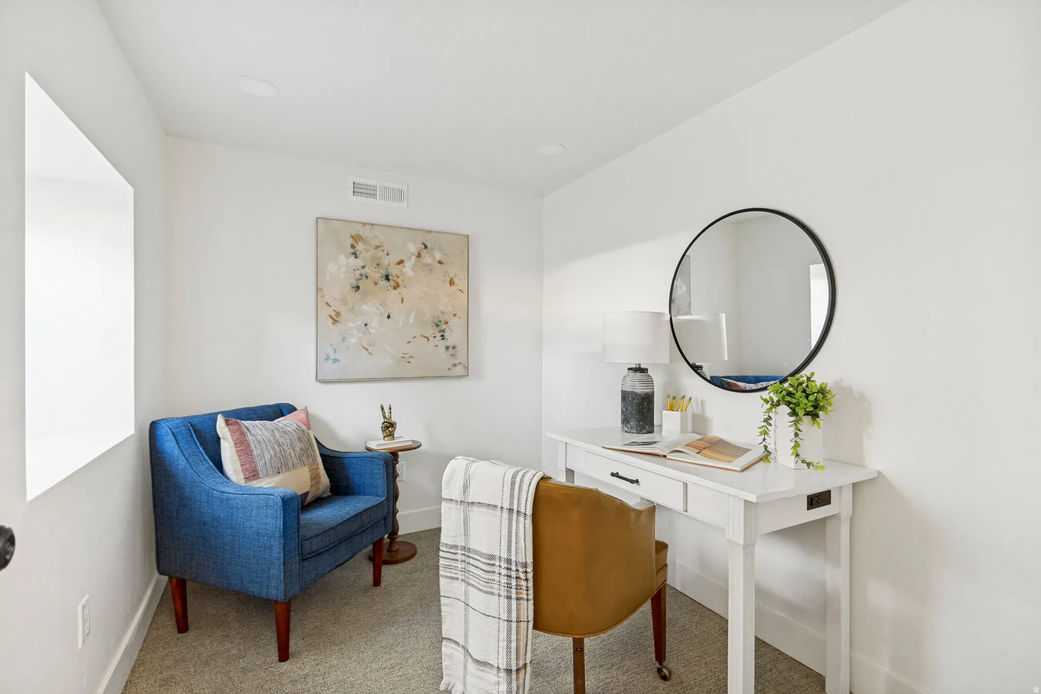 Neutral wall finishes and recessed lighting complement the carpeted flooring