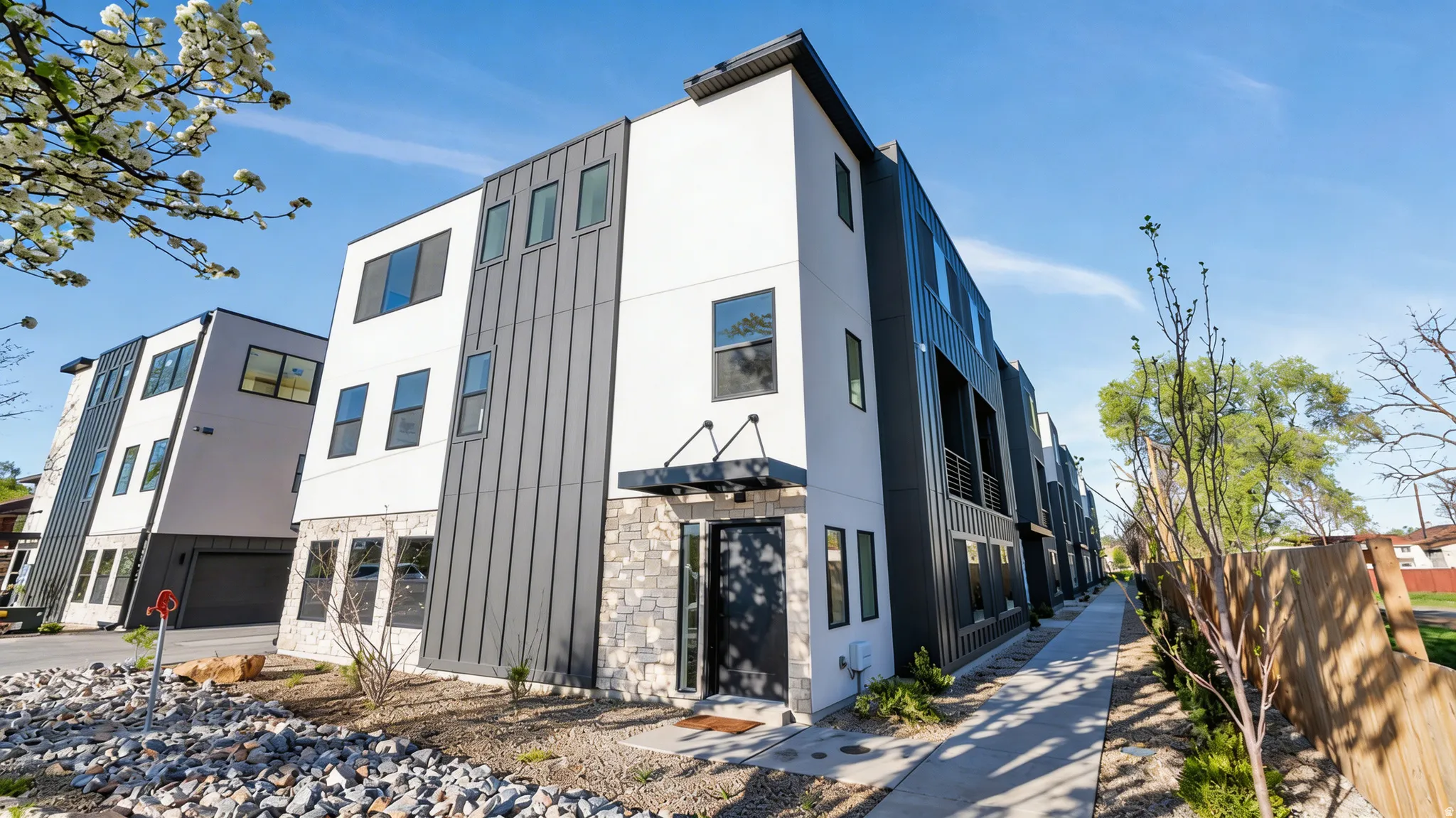 Modern townhome exterior featuring clean lines and a multi-textured facade
