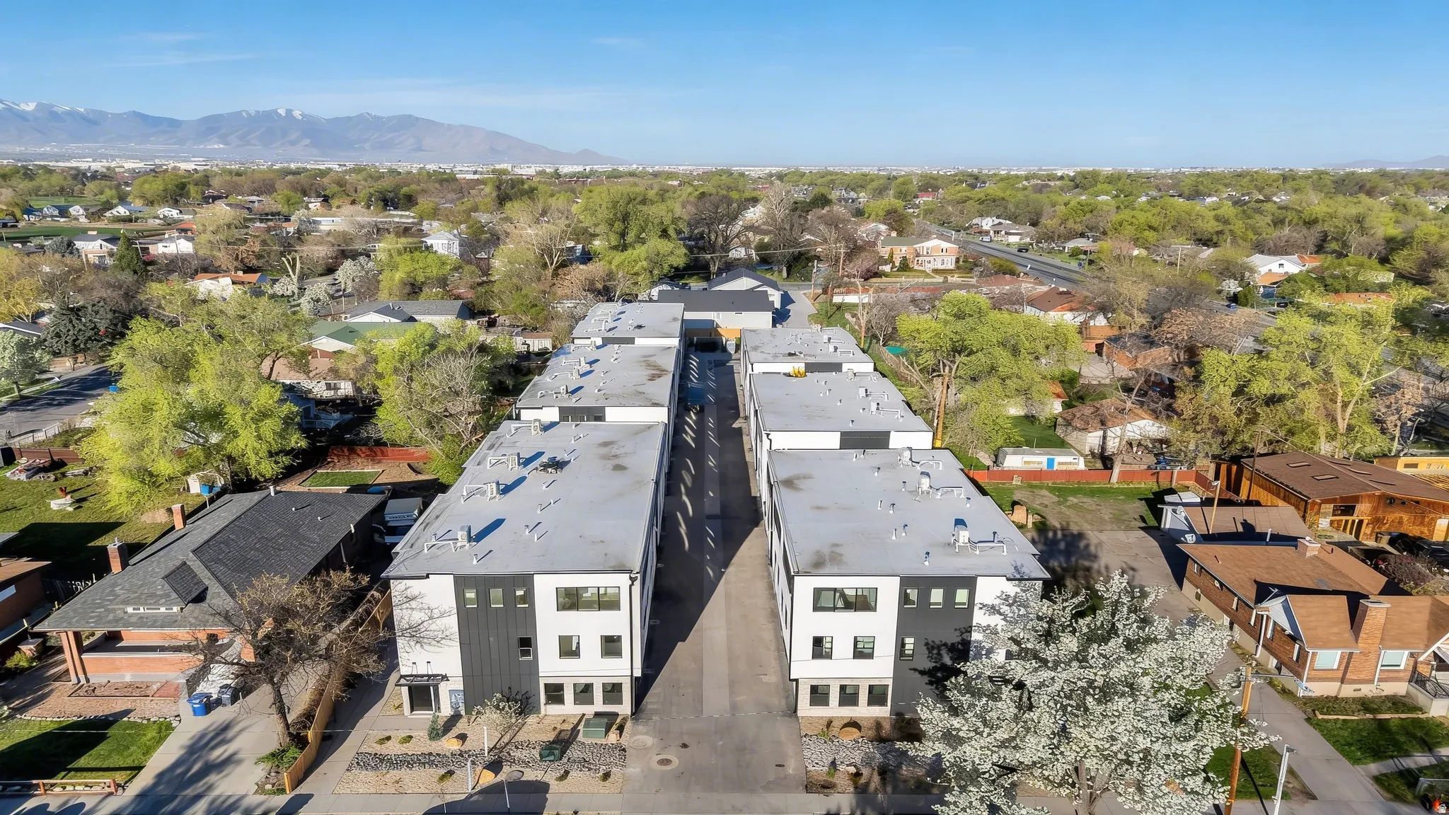 Modern townhome development with a combination of white and dark gray exterior finishes