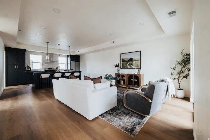 Open-concept living space featuring wood-finish flooring