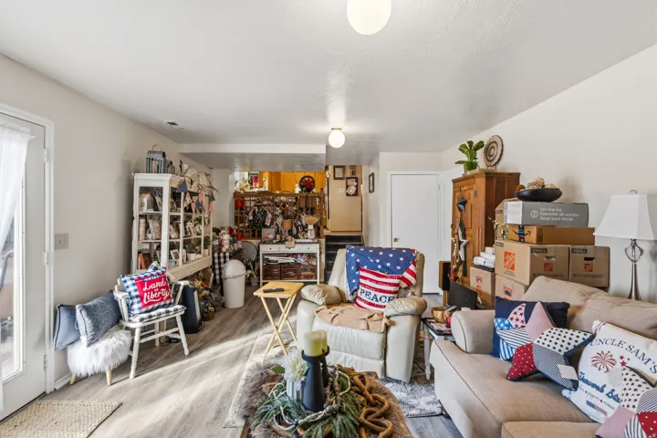 Spacious room featuring wood-finish flooring, white walls, and recessed lighting