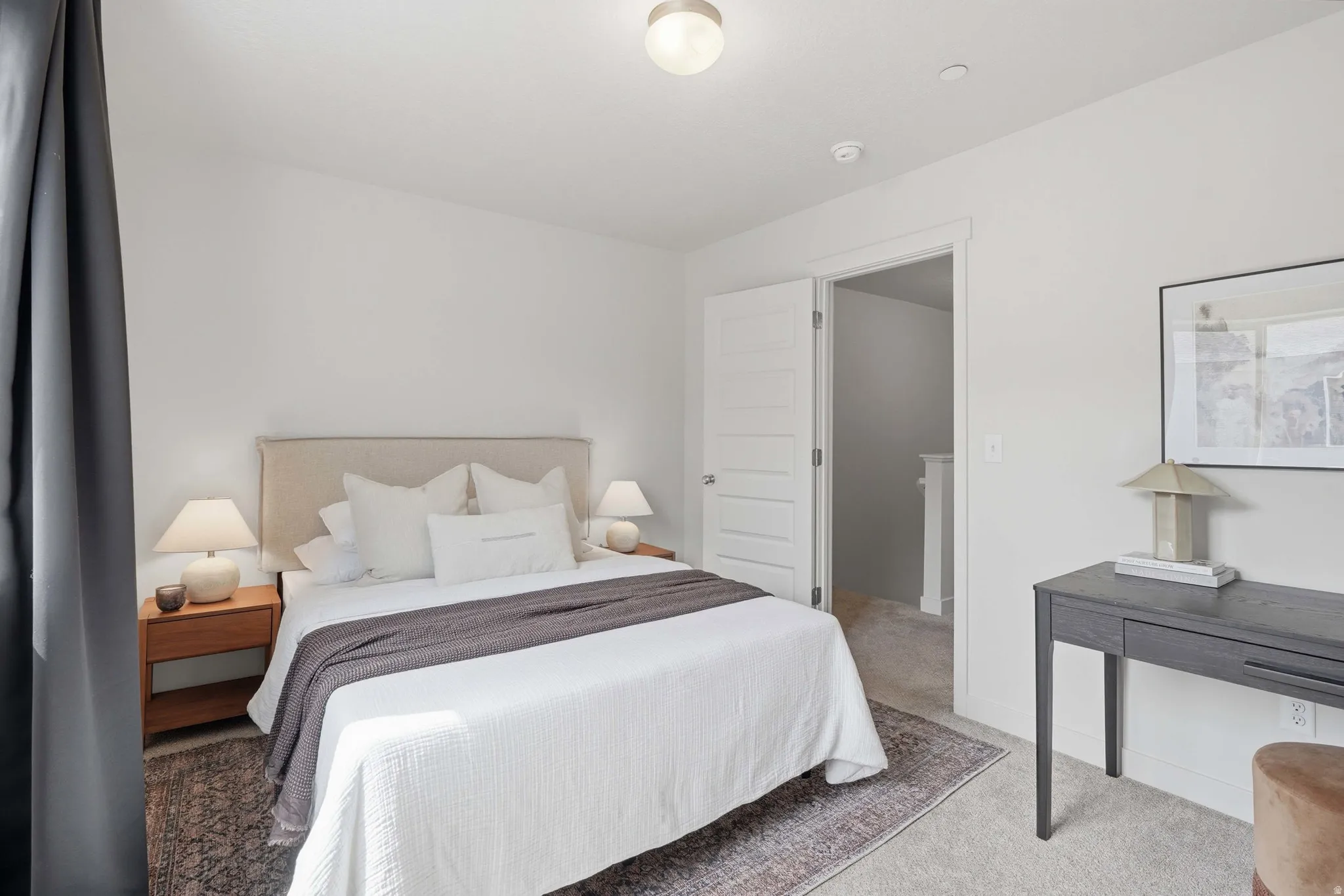 Bedroom featuring neutral wall colors, carpet flooring, a contemporary ceiling light fixture, and a paneled interior door