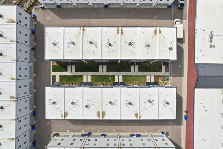 Modern multi-unit property with flat roofs and rooftop HVAC units