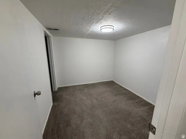 Neutral wall finishes and gray carpet flooring