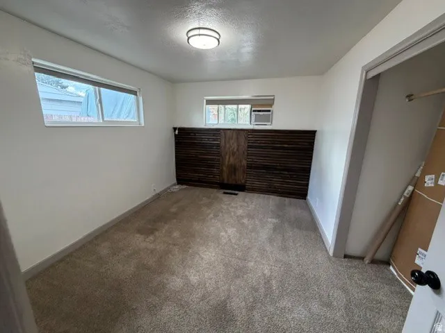 White painted walls with a dark wood-paneled accent wall