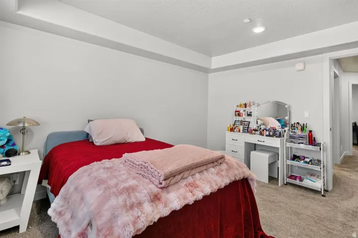 Bedroom featuring light gray walls, carpeted flooring, and a recessed ceiling light