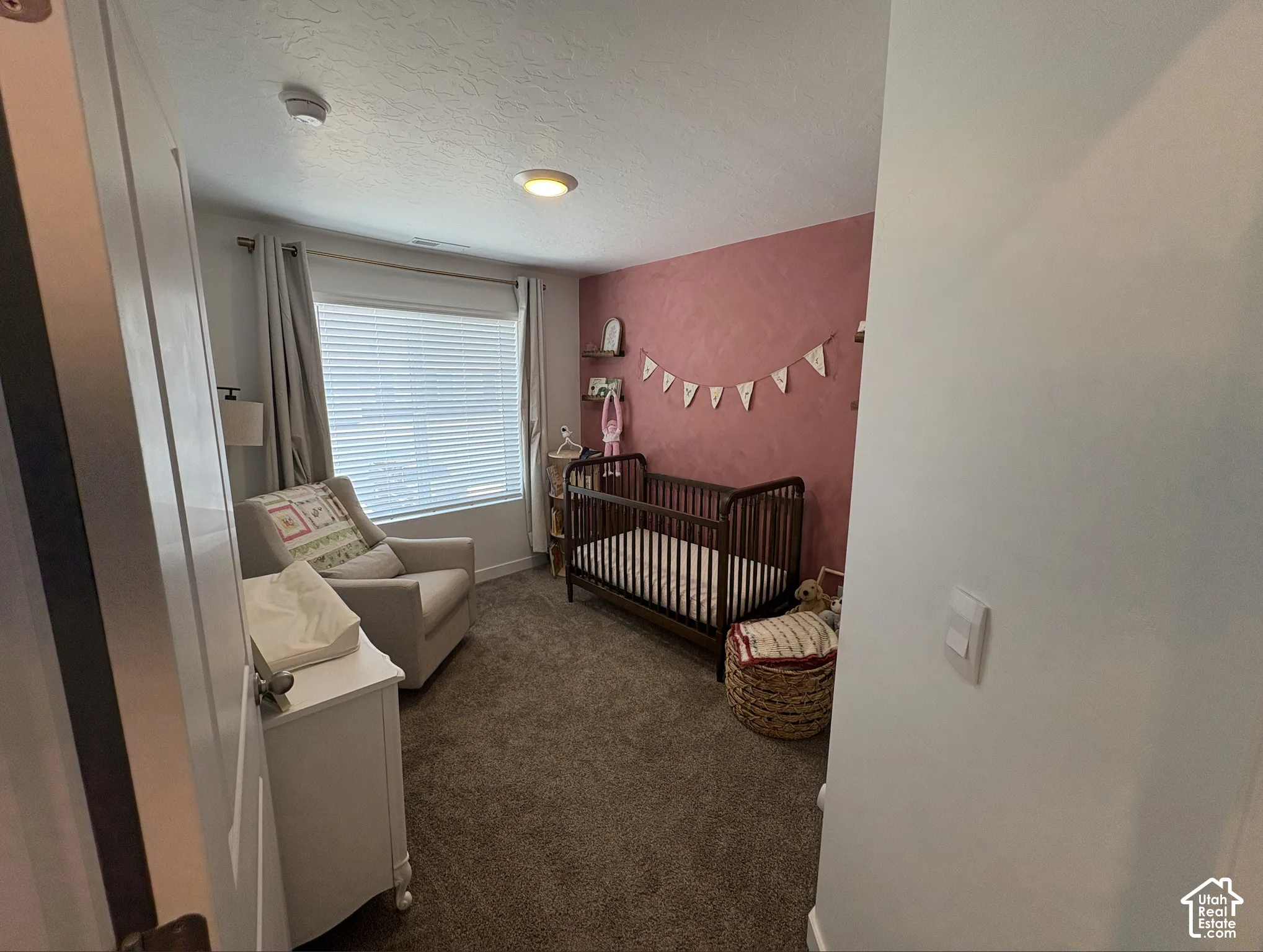 Room featuring plush carpeting, a large window with blinds, and a recessed ceiling light fixture