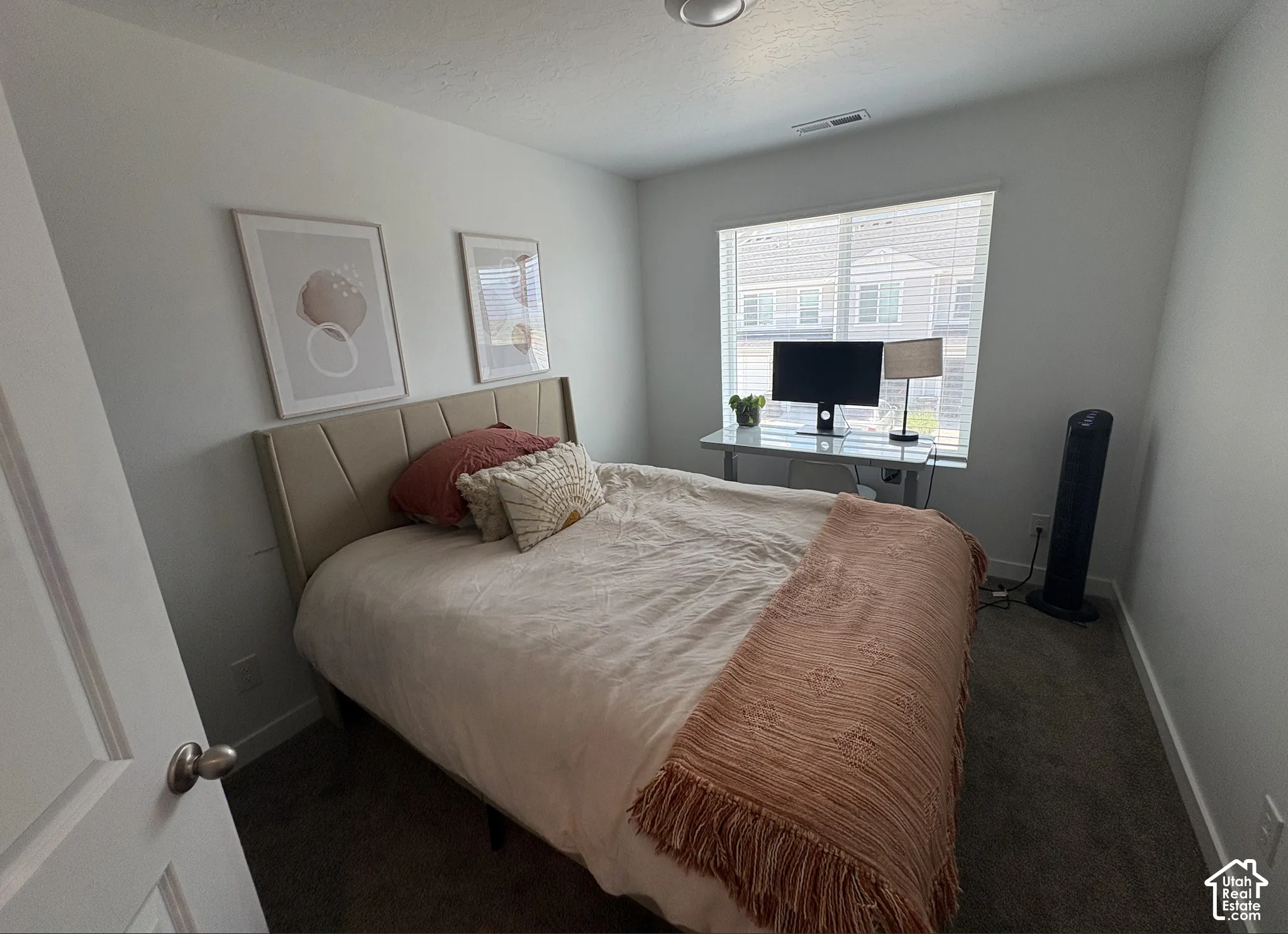 Carpeted room featuring light-colored walls and a window with blinds