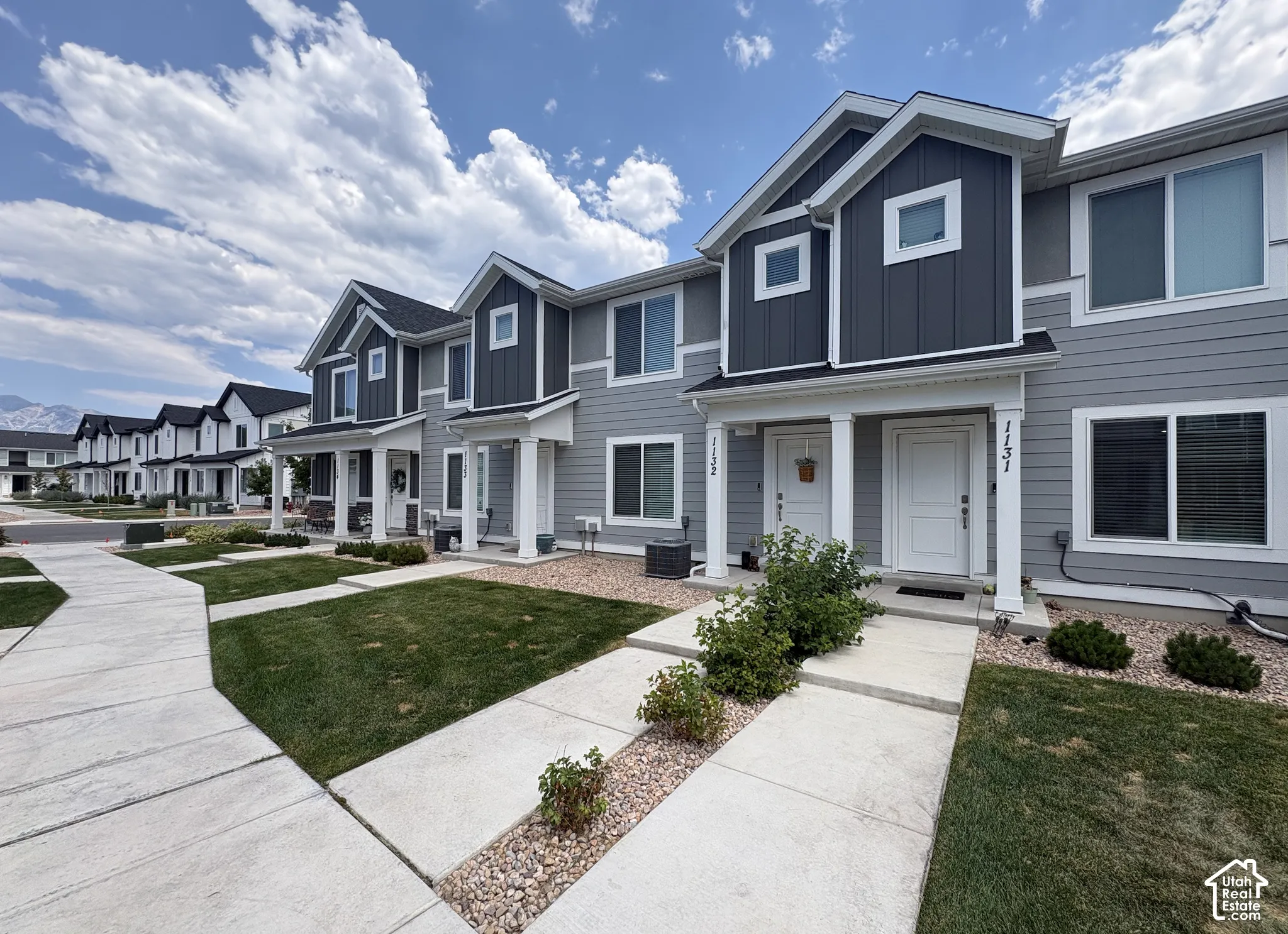 Modern townhome exterior featuring gray horizontal siding and dark gray vertical siding accents