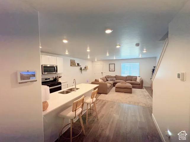 Open-concept layout featuring wood-finish flooring