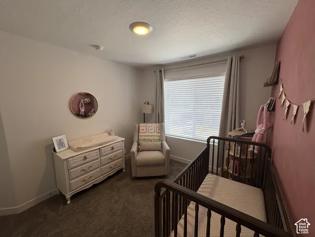 Carpeted room featuring a large window with blinds and drapes, a recessed ceiling light, and a two-tone wall finish
