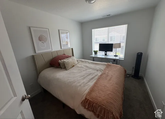 Carpeted room featuring light-colored walls and a window with blinds