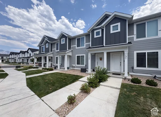 Modern townhome exterior featuring gray horizontal siding and dark gray vertical siding accents