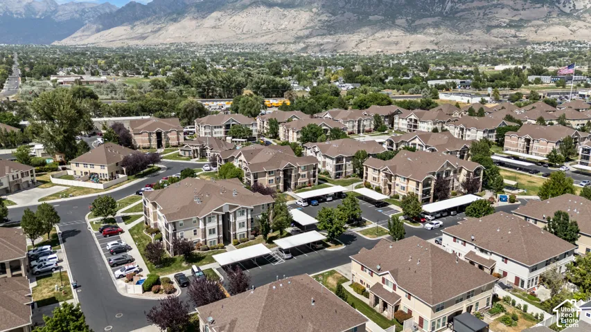 Expansive community featuring multi-story residential buildings with tan siding and brown shingle roofs