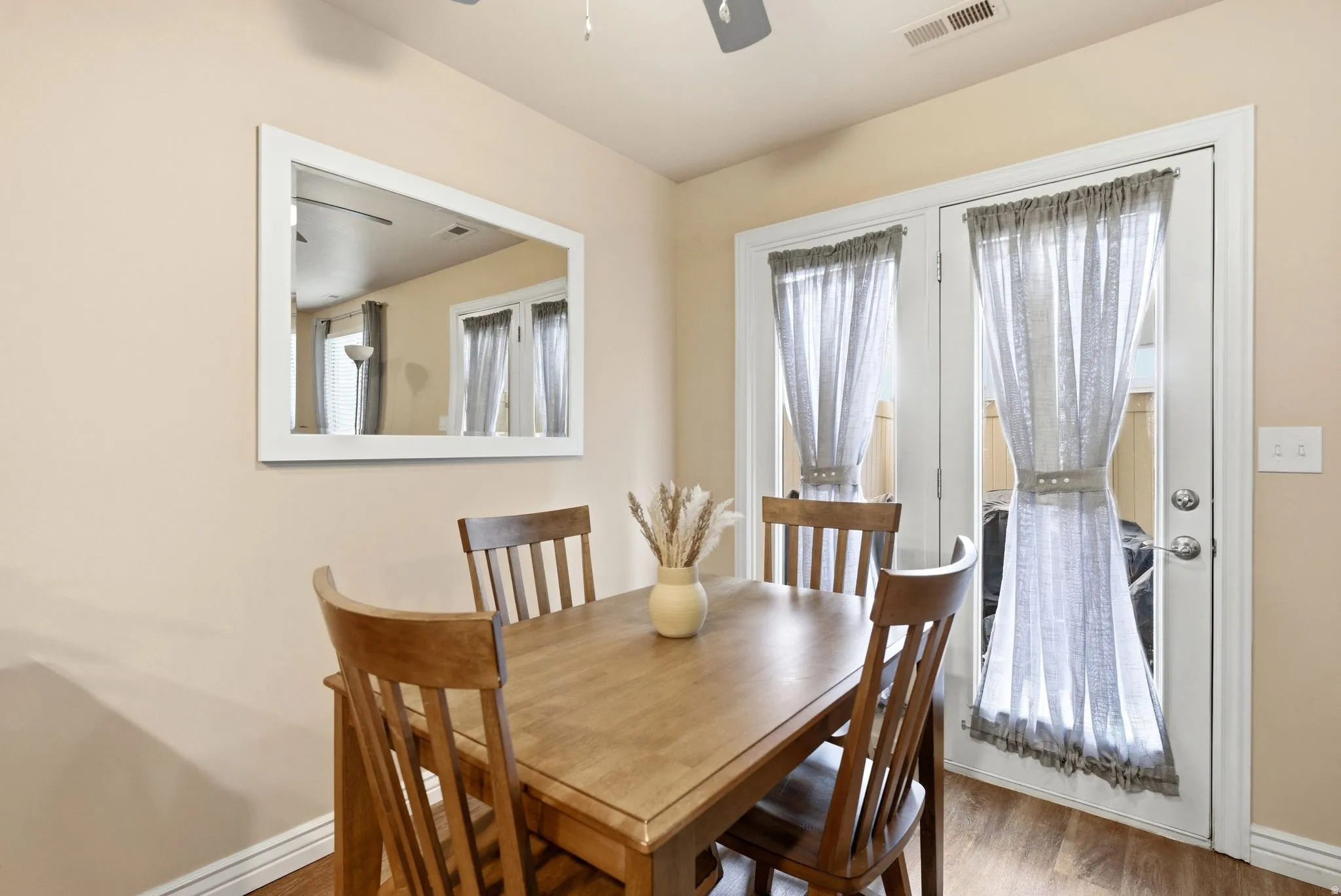 Dining space featuring wood finished floors and ceiling fan
