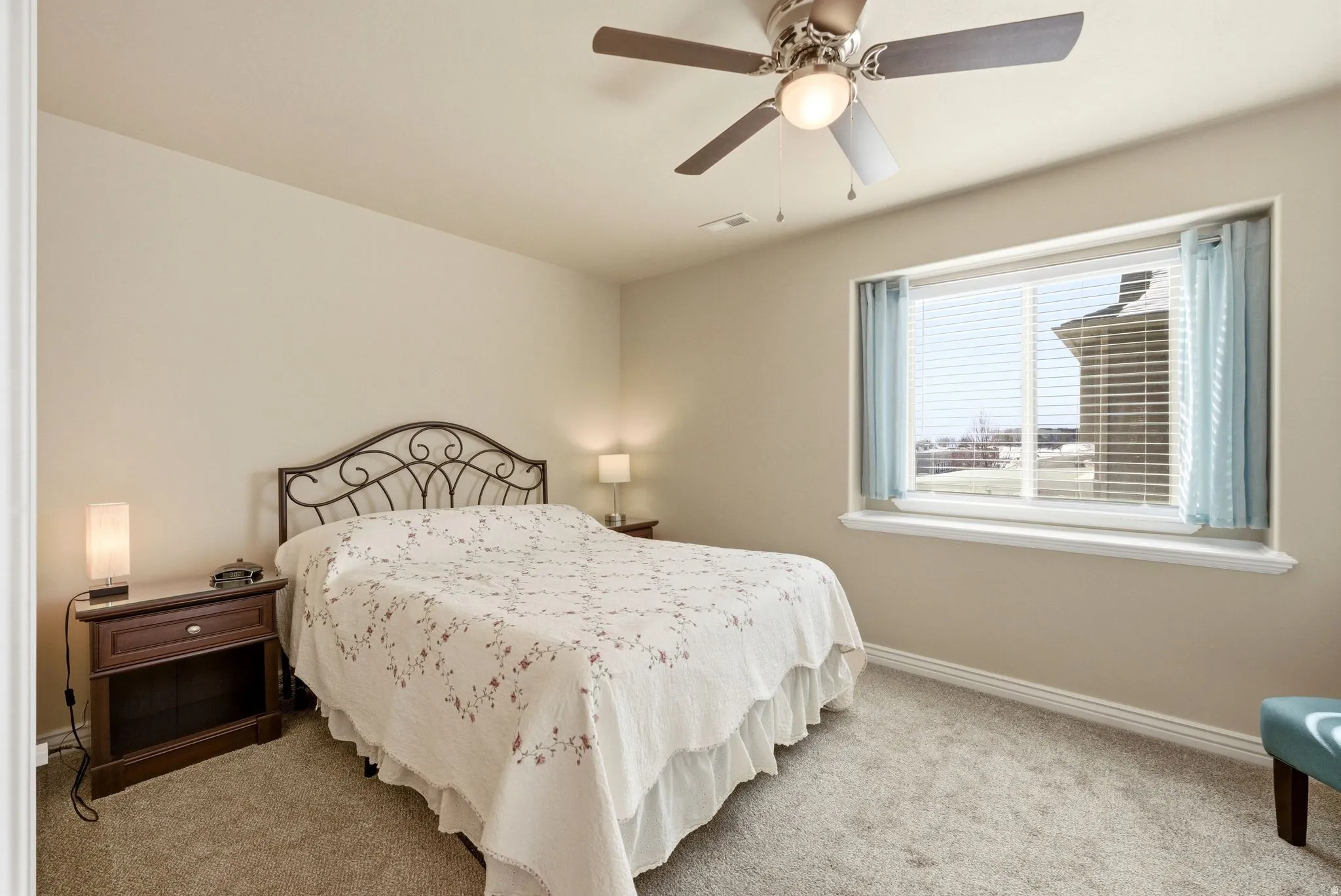 Primary Bedroom featuring light colored carpet and a ceiling fan
