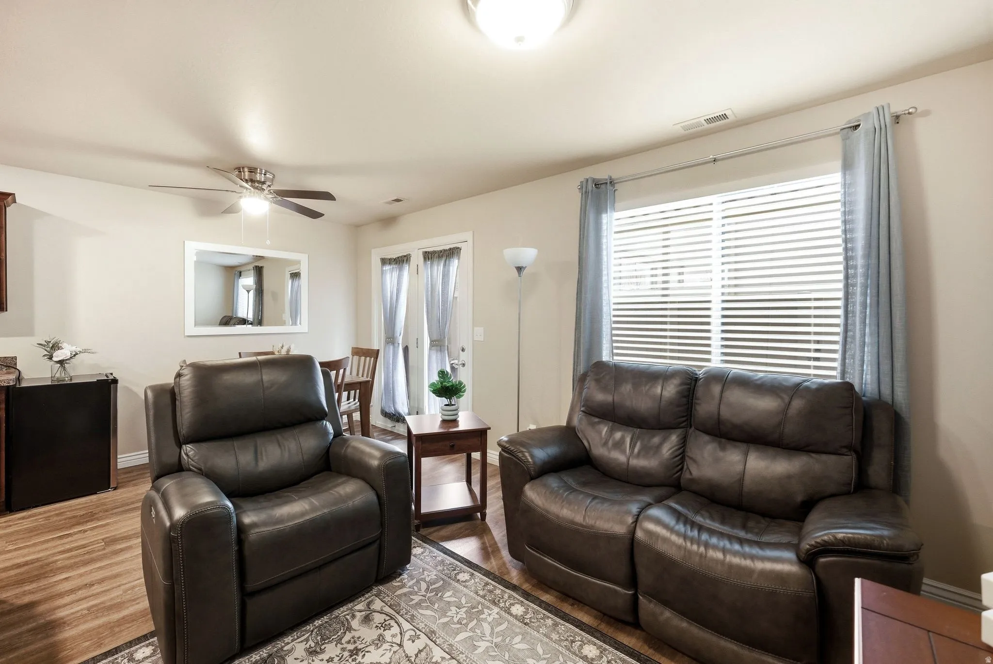 Living room with wood finished floors and ceiling fan