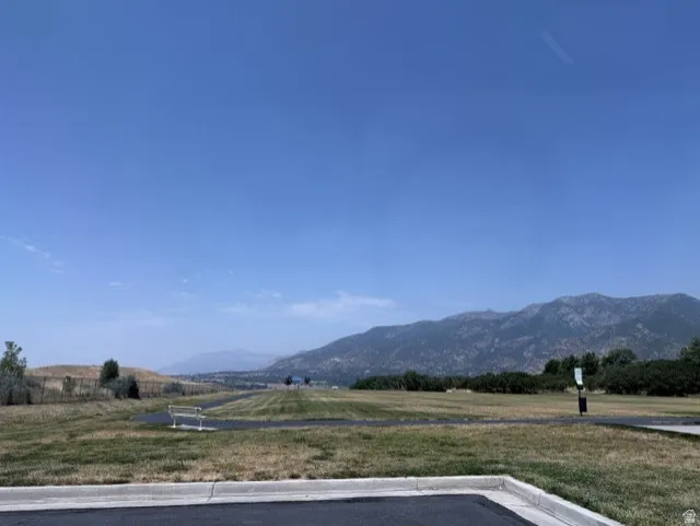 Expansive natural landscape featuring distant mountains and a clear sky