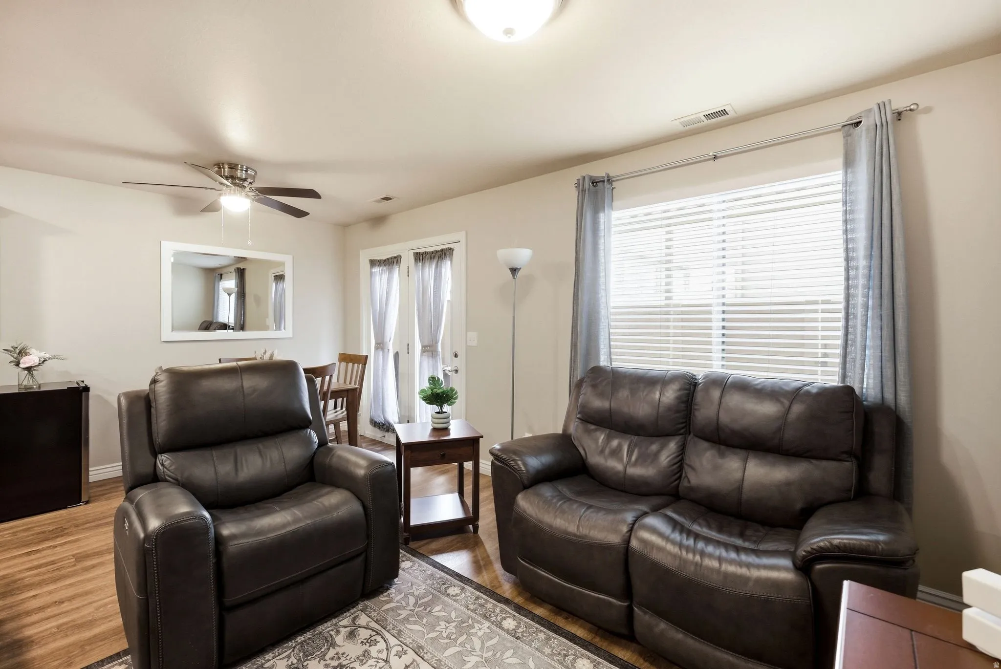 Living area featuring wood finished floors and ceiling fan