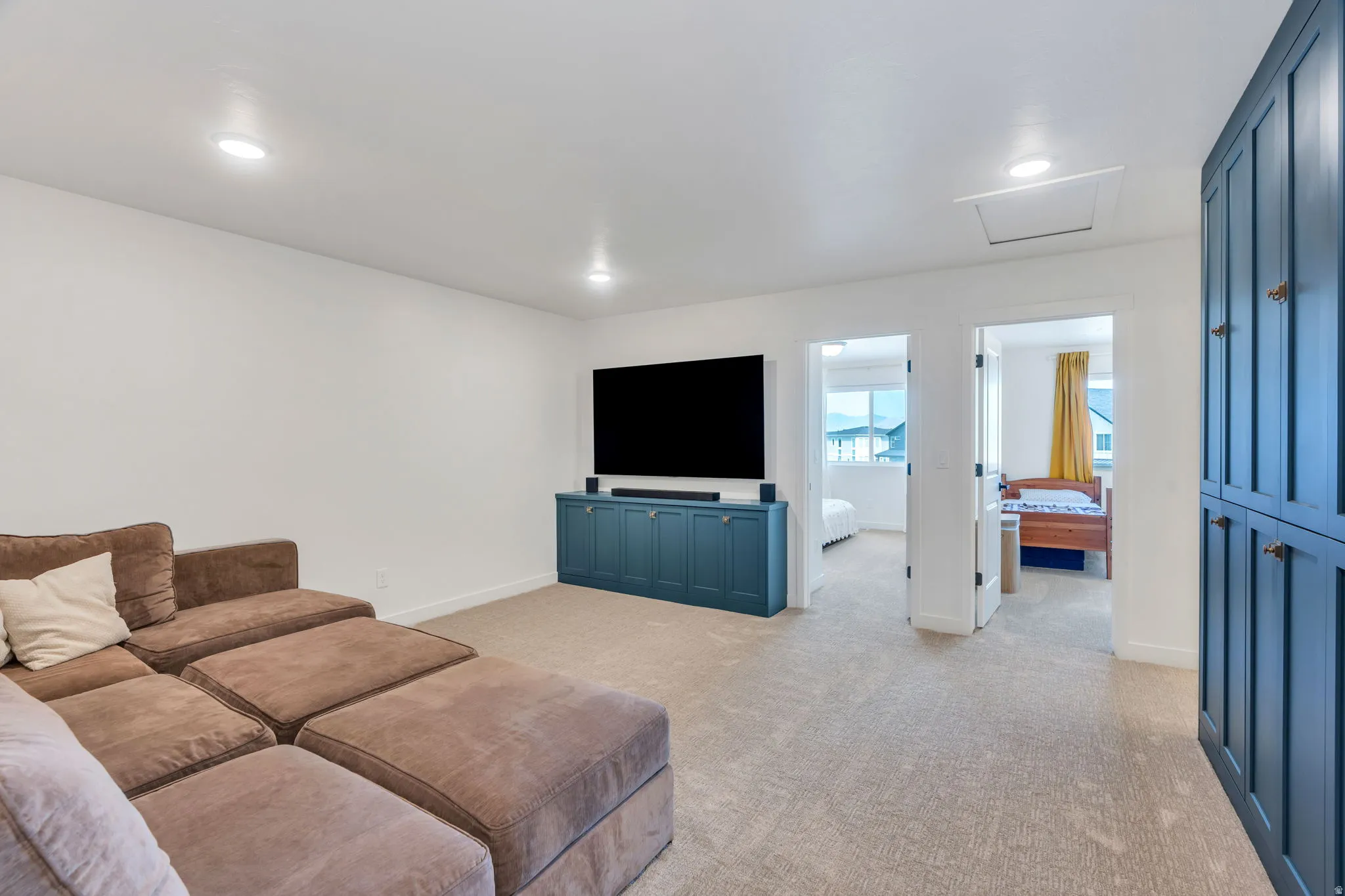 Carpeted living area featuring recessed lighting and white walls
