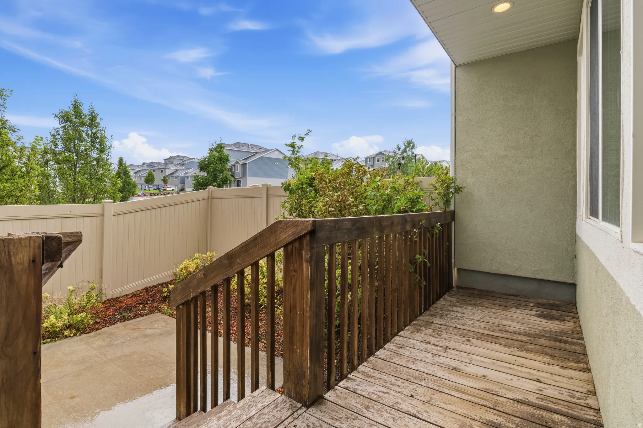 Outdoor wood-finish deck with built-in railing