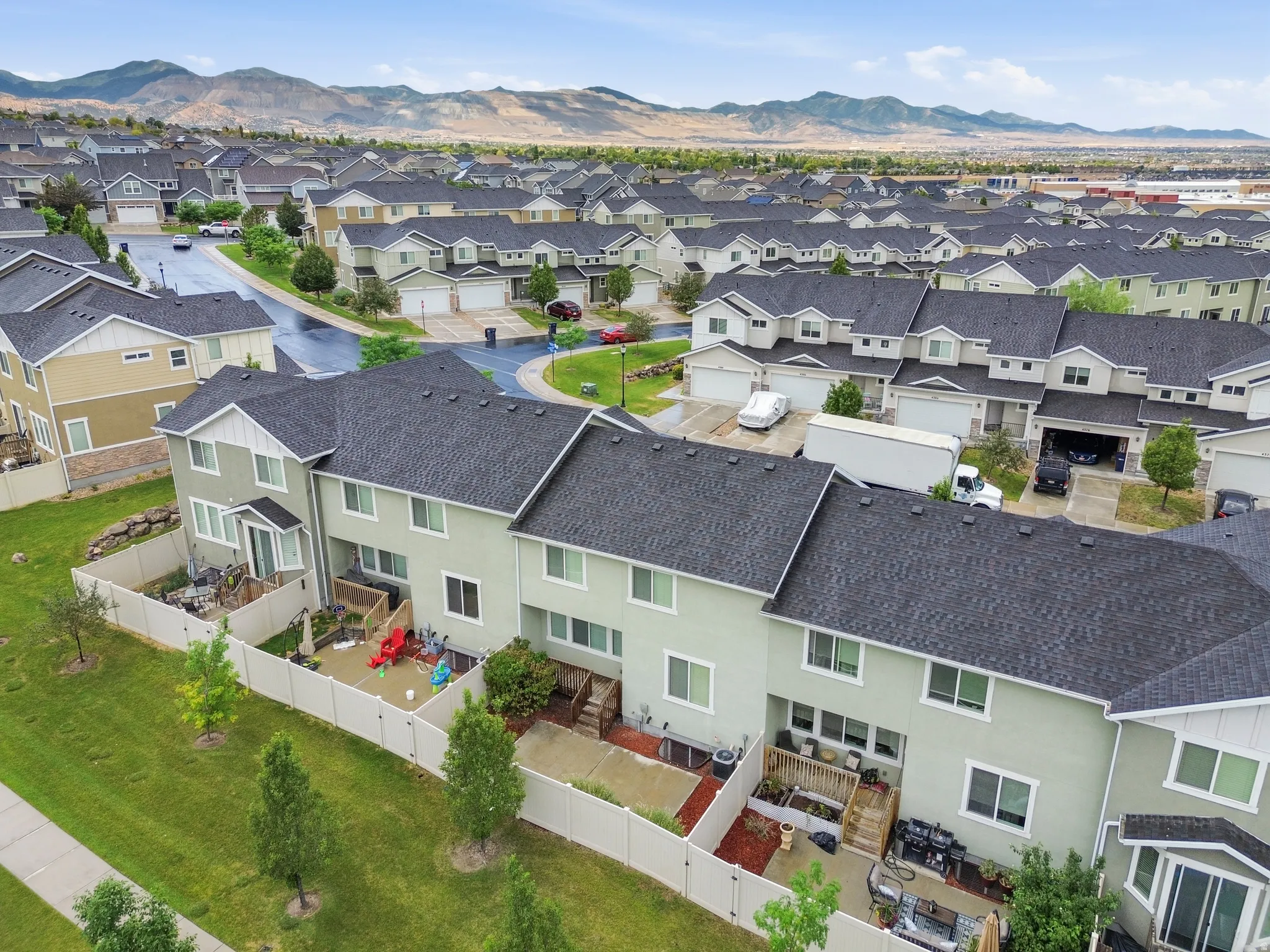 Aerial perspective showcasing a residential community with distant mountain ranges