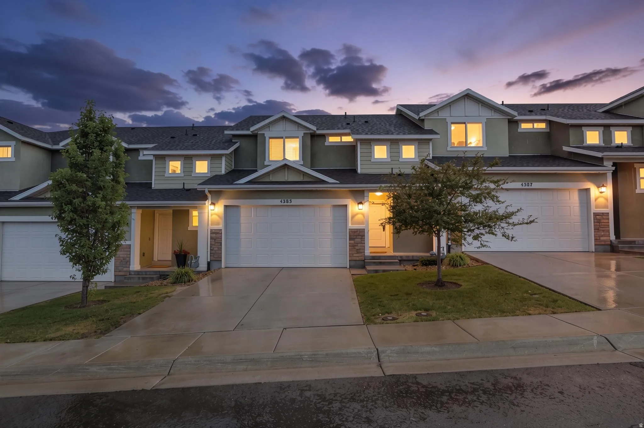 Row of townhomes featuring light green siding and dark rooflines