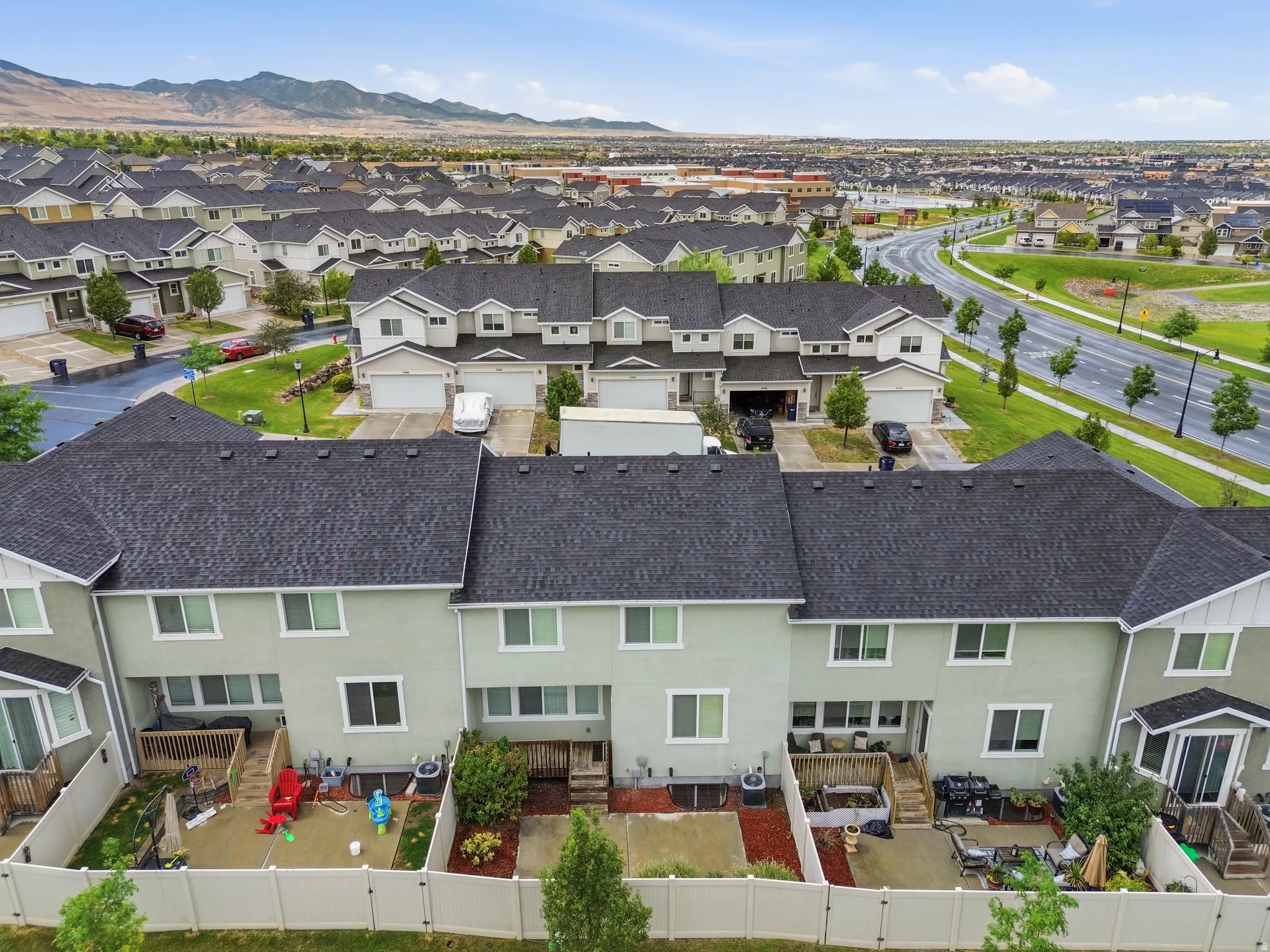 Townhome community featuring private fenced yards, multi-story residences, and attached garages