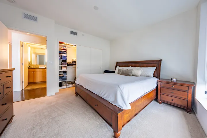 Plush carpeting throughout, dedicated dressing area with custom built-ins, and recessed lighting