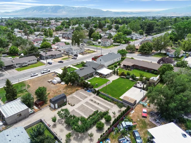Expansive grounds featuring a spacious lawn, paved patio area, and mature trees
