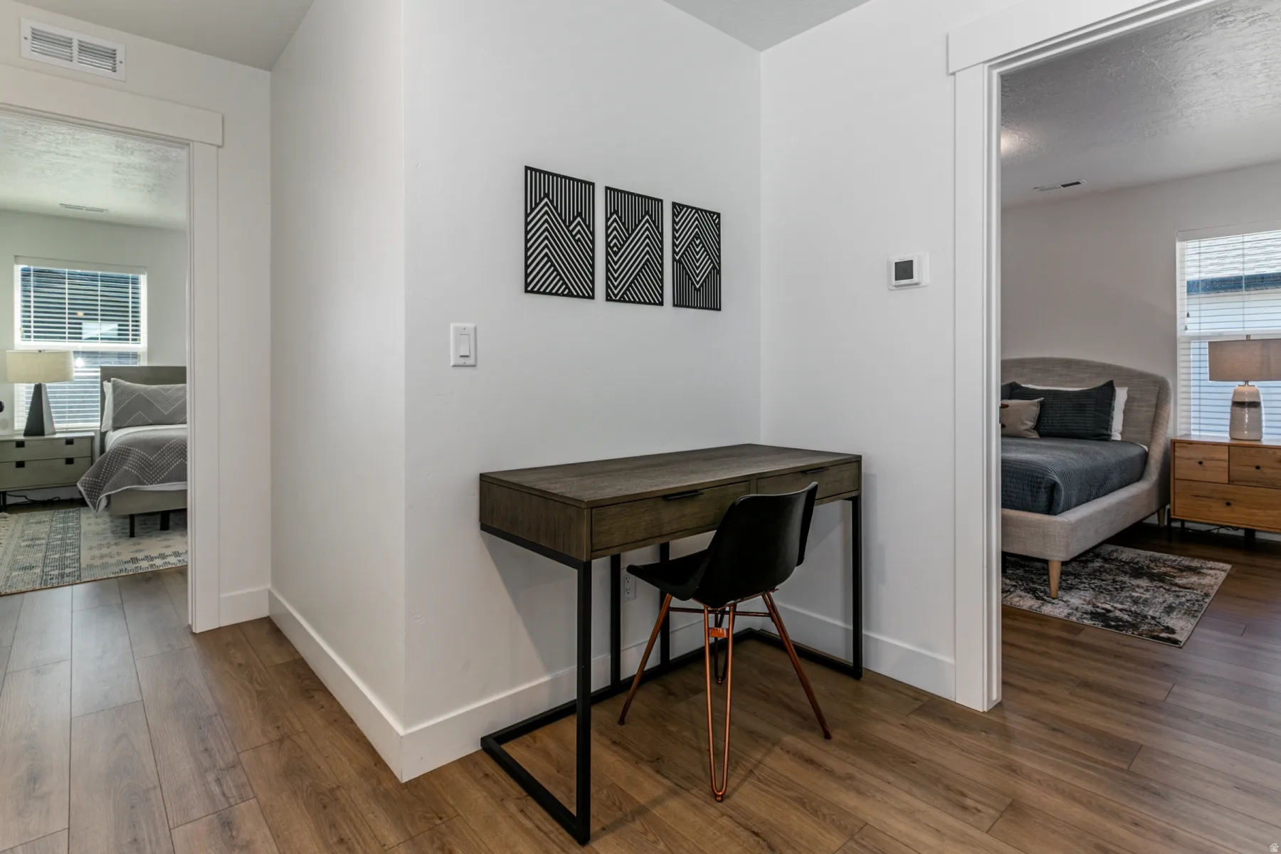Wood-finish flooring throughout, bright white walls, and contemporary trim work