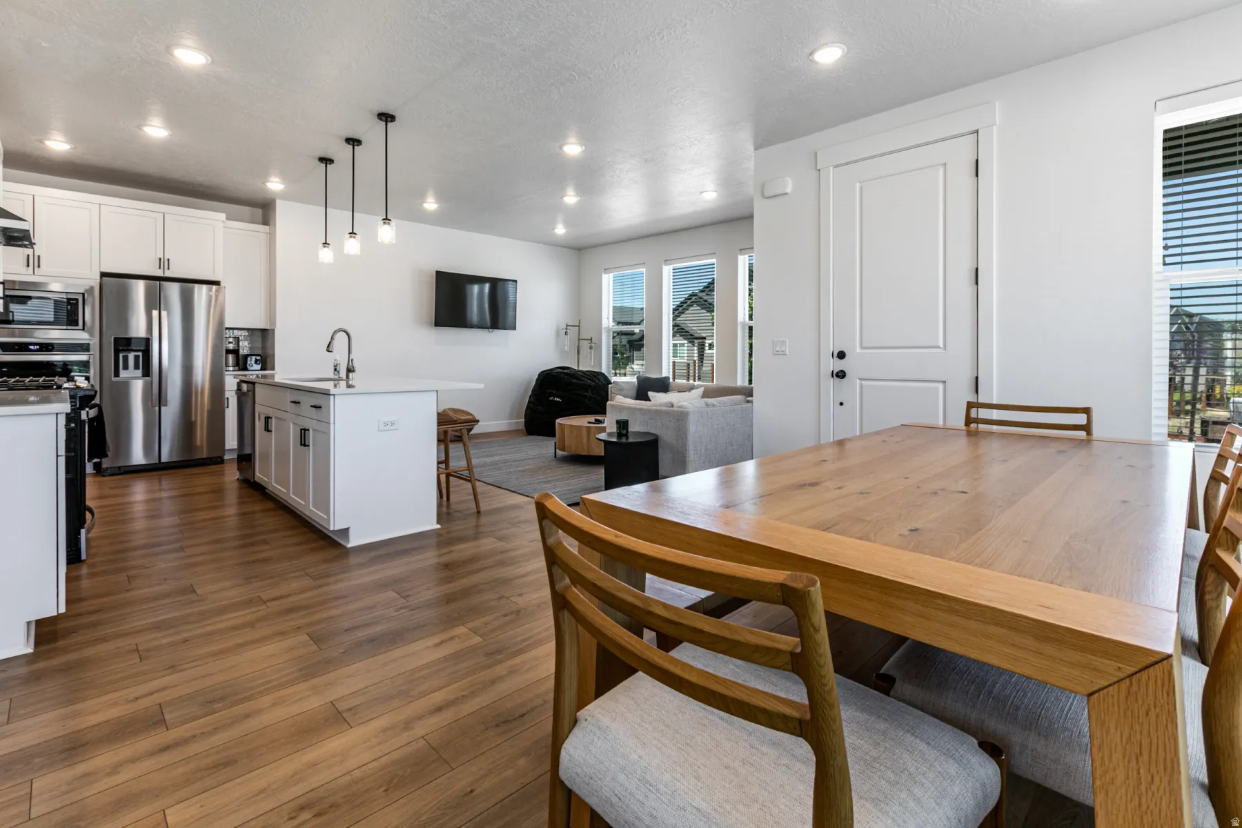 Open-concept living space with wood-finish flooring extending throughout