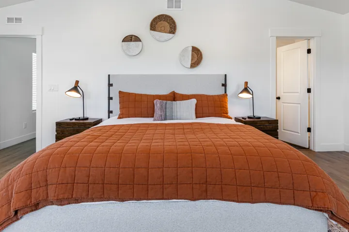 Bedroom featuring a vaulted ceiling and light wood-finish flooring