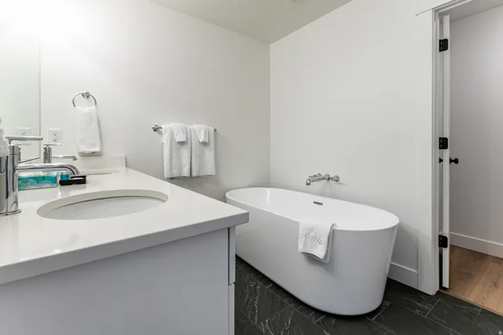 Modern bathroom featuring a freestanding soaking tub with wall-mounted fixtures