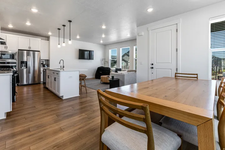 Open-concept living space with wood-finish flooring extending throughout