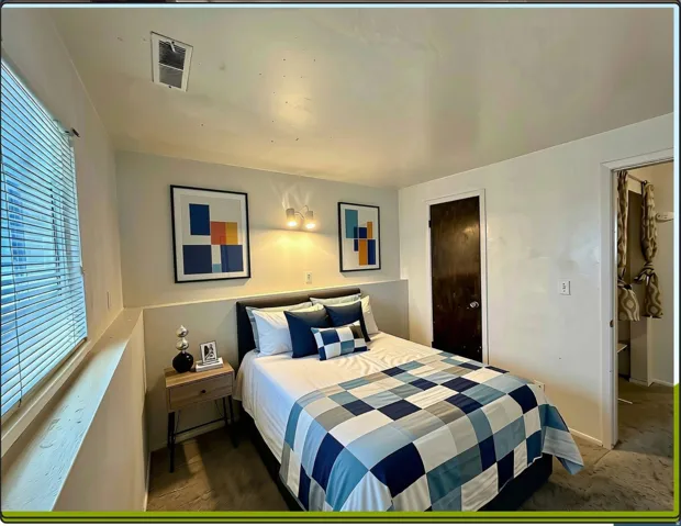 Bedroom featuring neutral wall colors, carpet, a window and closet