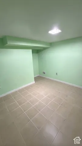 Interior room featuring ceramic tile flooring, neutral wall paint, and a ceiling-mounted light fixture