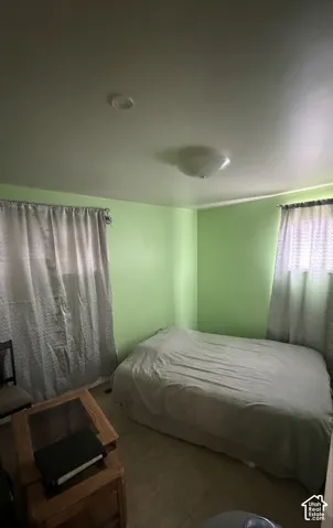 Room with light green walls and ceramic tile flooring