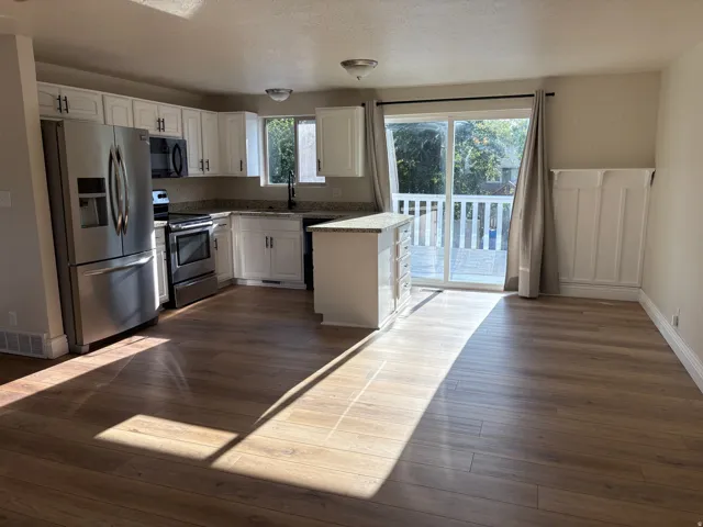 Kitchen with white cabinetry, stainless steel appliances, and granite countertops
