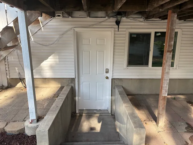 White paneled entry door with an exterior light fixture