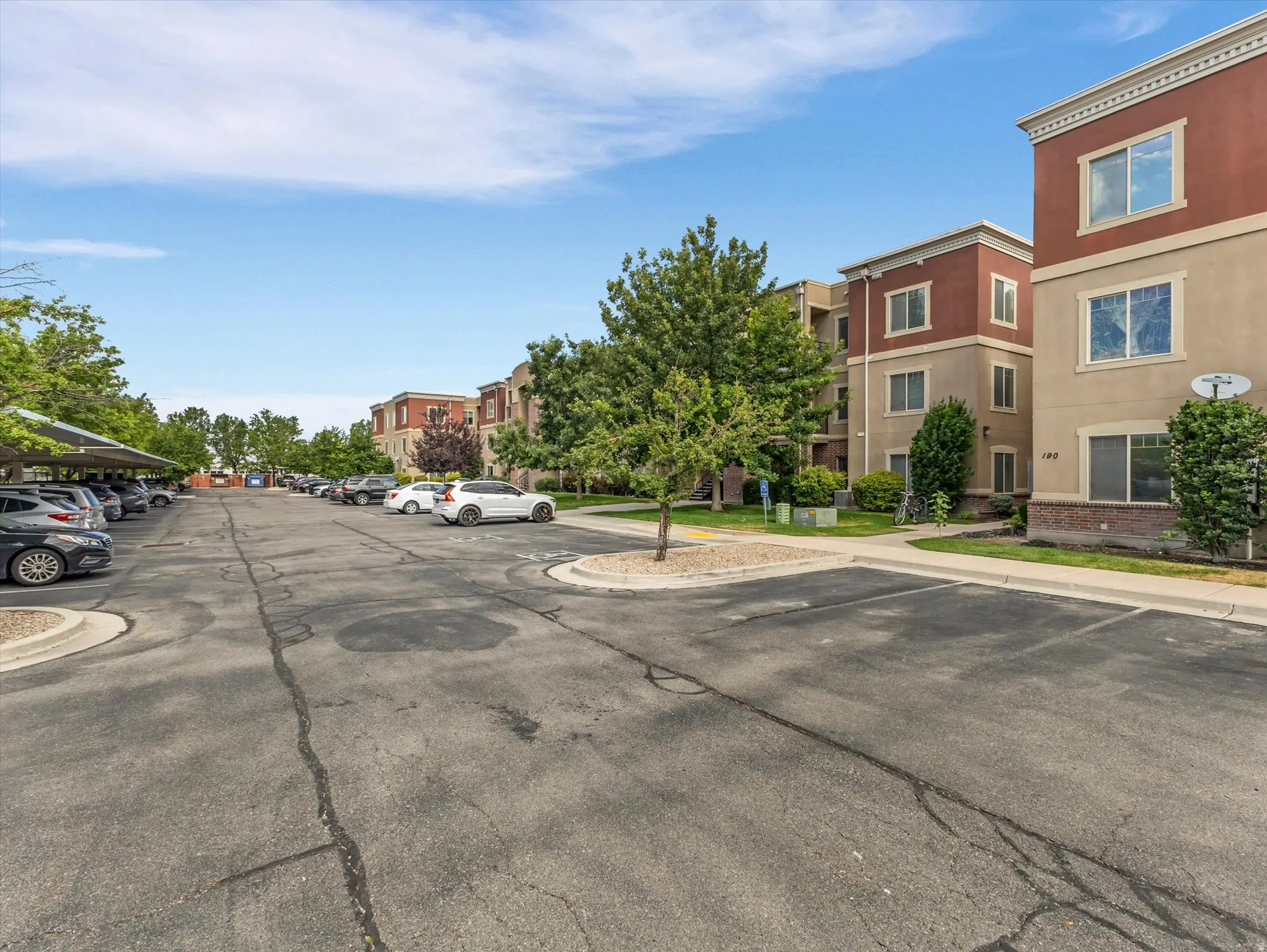 Multi-story stucco buildings featuring contrasting trim and brick accents