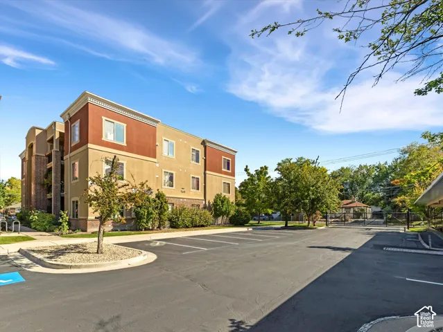 Multi-story building featuring a stucco exterior with decorative trim