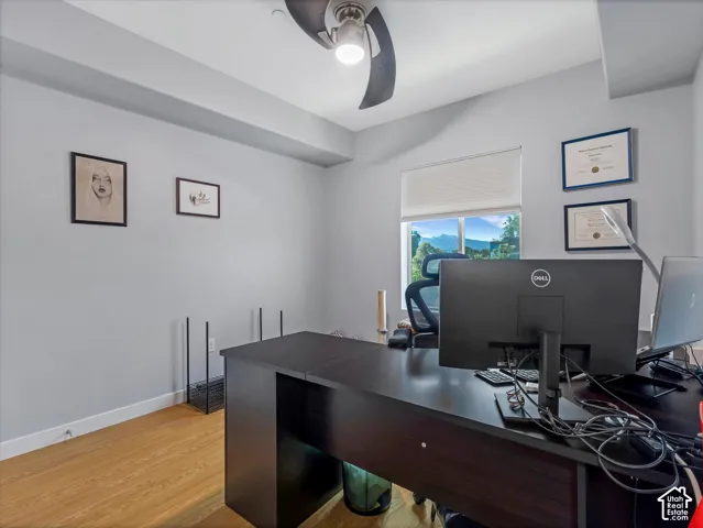 Neutral wall paint, wood-finish flooring, and a large window with mountain scenery